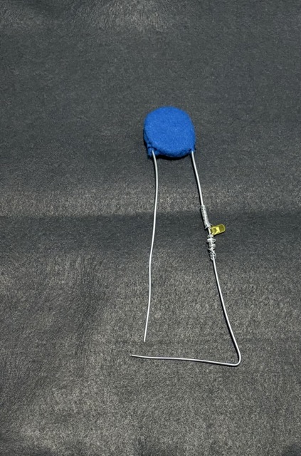 Using the same design from the purse, I created another battery pouch. But the coils in this one are bigger and the stitches are tighter so that there is constant contact. The wires at the bottom are the ones that close the circuit when they come in contact with a conducive material.